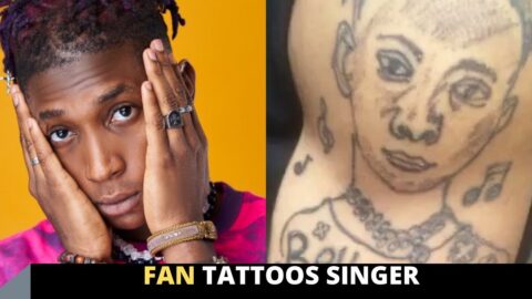 Fan tattoos singer Bella Shmurda on his arm