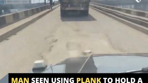 Man seen using plank to hold a truck with no brake in Lagos