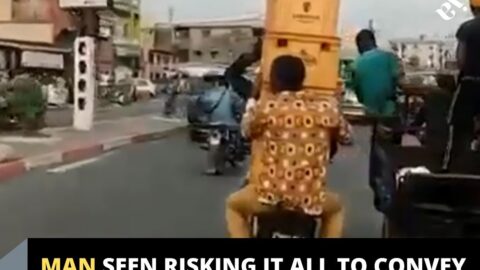 Man seen risking it all to convey a tower of beer crates with a bike